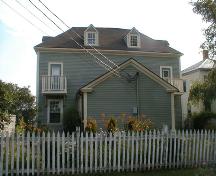 The building sits tight to the front (South) and side (East) property lines, allowing for a maximum yard in the rear.; PNB 2005