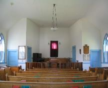View of church interior featuring varnished wood chancel rail, 2004.; Government of Saskatchewan, Lisa Dale-Burnett, 2004.