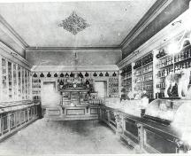 Interior view to the rear of the store with interior furniture still there today – ca. 1905; Ontario College of Pharmacists – ca. 1905