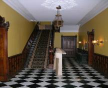 View of the interior central staircase and door to rear and dining room – 2006; OHT, 2006