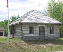 View of front of Tall Spruce School featuring its log construction.; Government of Saskatchewan, B. Quiring, 2005