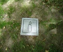 Featured is one of the stone markers marking the burial place of over 140 black settlers.; Kendra Green, 2007.