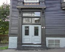 This photograph shows the entrance of the home with bracketed entablature and transom windows, 2005; City of Saint John