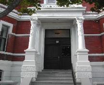 This photograph shows the elaborate entrance of the building, and illustrates the four corinthian columns under a flat portico, 2005
; City of Saint John