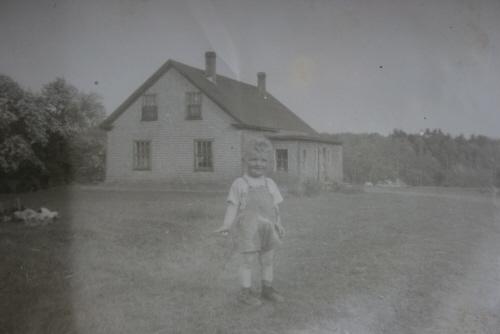 Showing child with house in background