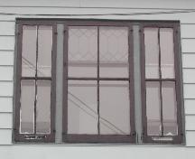This image shows a triple vertical sliding wood window with leaded glass, 2005; City of Saint John
