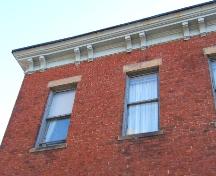 This photograph shows the overhanging cornice, 2005; City of Saint John