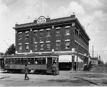 This historical image, dating from 1916, illustrates the front, west-facing primary facade of the building on 97th Street, an important arterial road connecting the McCauley neighbourhood with the downtown as evidenced by the streetcar line.; Glenbow Archives; McDermit Studio; NC-6-2382