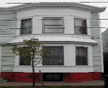 This image provides a view of the two storey, semi-octagonal bay window on the east side of the front façade, 2005; City of Saint John
