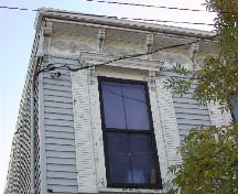 This photograph shows the cornice and one of the windows with ornate entablatures, 2005; City of Saint John