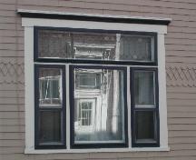 This photograph shows one of two triple set windows and illustrates the Arts and Crafts detailing in the transom, 2005; City of Saint John
