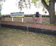 View of school yard, with mounted bell in foreground, 2008.; Government of Saskatchewan, Marvin Thomas, 2008.