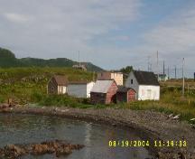 Photo view of William and Cecilia O’Neill Property from the oceanside, Conche, showing store, stable and house and environs, 2005; Joan Woodrow/HFNL 2008