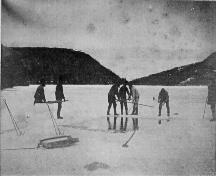 Historic photo showing men cutting ice on Beaver Pond, Harbour Breton, NL. Date unknown.; Sunny Cottage Heritage Centre 2009
