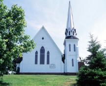 View of the exterior of Tryon United Church, showing its simple, bold form and composition, including its prominent, almost freestanding tower, and its massive, uninterrupted horizontal surfaces, 1995.; Parks Canada Agency / Agence Parcs Canada, J. Butterill, 1995.