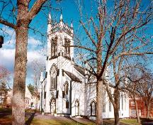 General view of St. John's Anglican Church, showing the entry façade with a rose window and twin towers, 1998.; Parks Canada Agency/ Agence Parcs Canada, 1998.