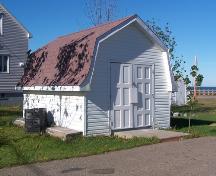 This image shows the shed in the same style as the house; Town of Shippagan