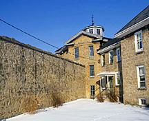 Exterior view of the Huron County Gaol, showing the two-storey-high walls, 1995.; Parks Canada Agency / Agence Parcs Canada, J. Butterill, 1995.