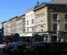 View of Granville Block, showing the similar four to five storey massings of the buildings with stone and brick façades, 2005.; Parks Canada Agency / Agence Parcs Canada, 2005.