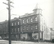 Historic image showing the Grace Building , circa 1898-1913, while under the ownership of John Anderson, as indicated by the store sign. ; HFNL/ 2006