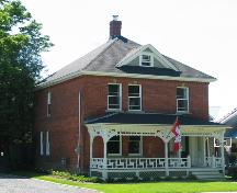 Front view of 844 George Street, showing the dormer and ornate front porch; City of Fredericton