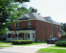 This image shows the front façade and the western side of residence; City of Fredericton