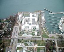 Aerial view of Kingston Penitentiary, showing the Greek cross (Auburn style) footprint of the original cellblock with its four three-storey wings, 1991.; Parks Canada Agency / Agence Parcs Canada, J.P. Jérôme, 1991.