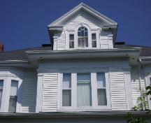 This photograph shows the classical dormer, the square upper bay window and the fluted corner boards, 2008; Town of St. Andrews