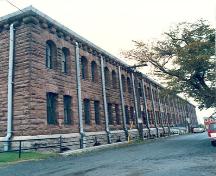 Corner view of a façade of the Halifax Drill Hall, 1990.; Department of National Defence/ Ministère de la Défence nationale, 1990.