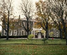 General view of Government House, showing the central entrance under a projecting portico, 1993.; Parks Canada Agency / Agence Parcs Canada, 1993.