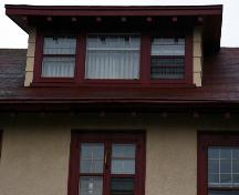 This image shows the Craftsman style shed dormer with wide overhang, modillions and three lights; City of Saint John