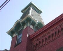 This photograph illustrates the upper portion of the tower and the elaborate brick work in the cornice, 2007; City of Saint John