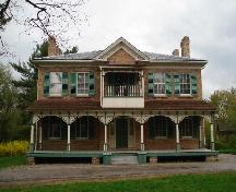 Of note are the symmetrical proportions of the main block and decorative Queen Anne style veranda.; Paul Dubniak, 2008.