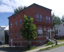 This photograph shows the contextual view of the corner building, 2009; Town of St. Andrews