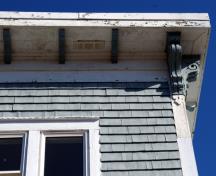 This image shows the cornice with exposed rafter tails and end brackets; City of Saint John