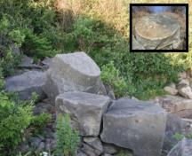 Remains of stones of the Beaumont Quarry consisting of two partially cut grindstones; Memramcook Valley Historical Society