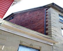 This image shows a side gable with roof pitch and quoins; City of Saint John, 2007