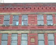 This photograph shows the corbel bands, the sandstone date stone, horizontal rows of sandstone.; City of Saint John