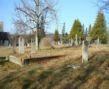 The Old North Head Cemetery has low cement walls leveling some family plots. Most of the cemetery is level with roads throughout.; Grand Manan Historical Society