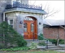 Featured is the entrance with its double wooden doors, mansard roof, balcony and railing.; City of Brantford, 2008.