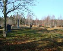 The cemetery is on level gound with some plots terraced and fenced with low cement walls and iron railings; Grand Manan Historical Society