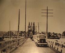 Historic photo of the Rexton Bridge showing the swing span open on the south end of the bridge, circa 1940; Village of Rexton