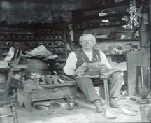 James Lawson at work on his cobbler bench; Grand Manan Archives photo collection - P40