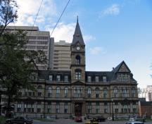Exterior view of Halifax City Hall, showing the three-storey massing, and the seven-storey clock tower with its clock and its steeply angled roof, 2006.; Parks Canada Agency / Agence Parcs Canada, 2006.