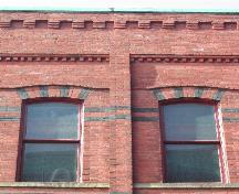 This is a photograph of the two upper floor windows, the cornice, and the pilaster that separates each bay, 2004.; City of Saint John