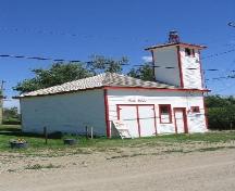 View east showing fire hall with bell tower and double doors of vehicle shed, 2004.; Government of Saskatchewan, Marvin Thomas, 2004.