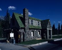 Façade of Building 1, showing the the front porch, the gable end of which frames the word “Register", 1985.; Parks Canada Agency / Agence Parks Canada, 1985.