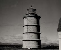 General view of the Lighthouse, showing the stone masonry construction of smooth, dressed ashlar stone, circa 1975.; Transport Canada / Transports Canada, circa/vers 1975.