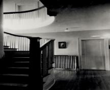 Interior view of the Former Superintendent's Residence, showing the surviving interior details, such as the woodwork and the curved staircase, 1989.; Parks Canada Agency / Agence Parcs Canada, 1989.