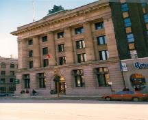 View of Postal Station H, showing the central arched entry and the buff sandstone, 1989.; Department of Public Works / Ministère des Travaux publics, 1989.